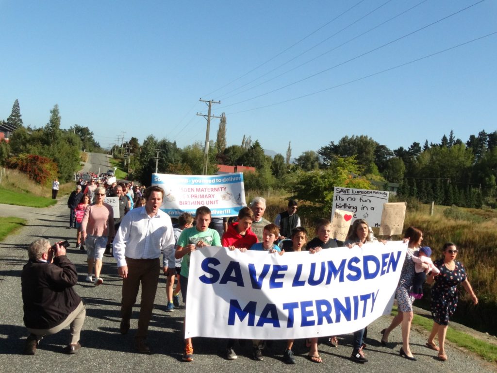 Large group of people marching in protest to save Lumsden Primary Birthing Unit