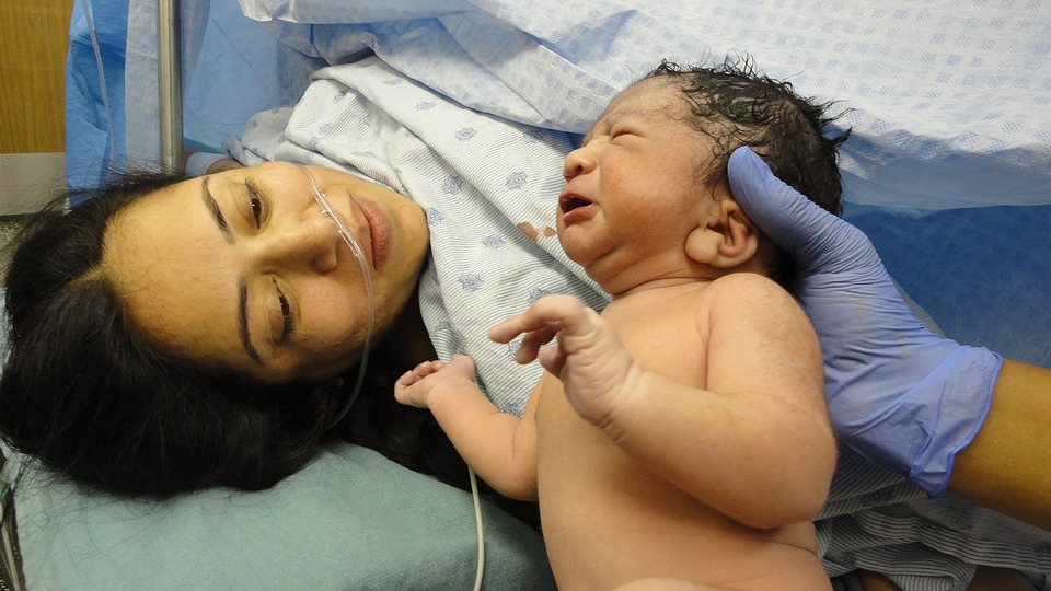 Mother sees her baby for the first time during caesarean surgery